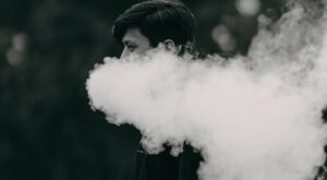 smoke coming out of a man's mouth